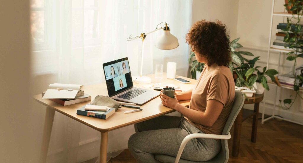 Freelancer working from home on laptop during online meeting